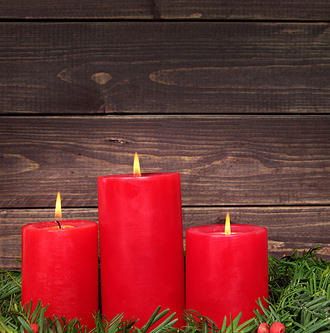 Festive scene of Christmas candles with decoration of Christmas tree against wood background